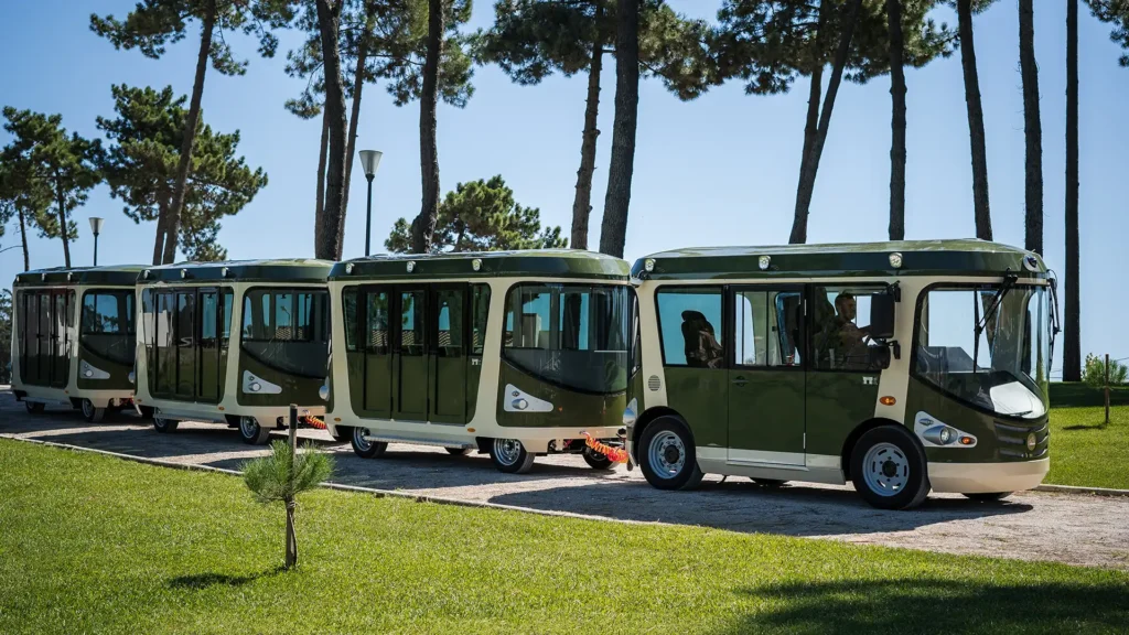 Deltrain Vision EV electric shuttle train in urban park environment