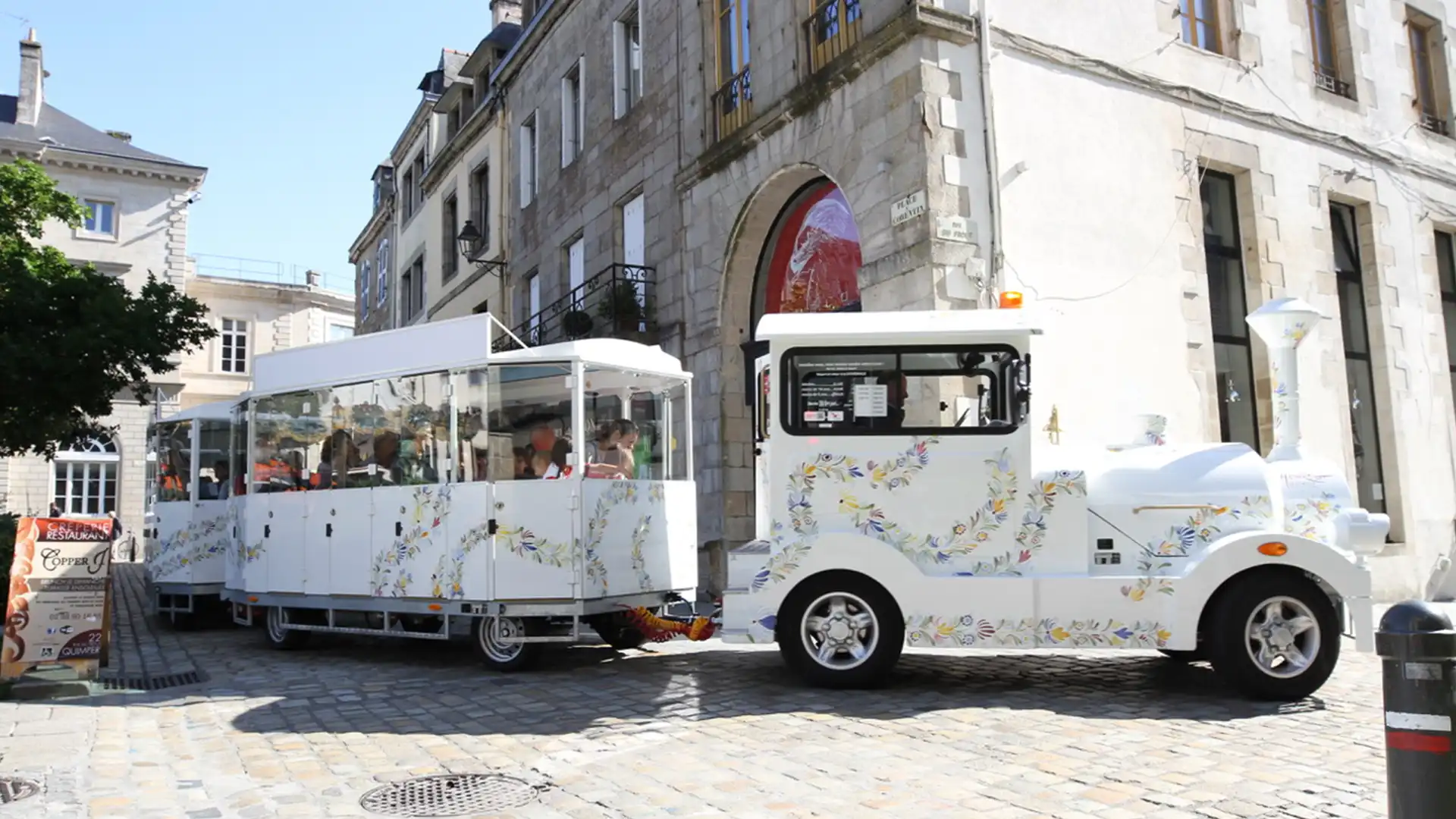 Deltrain Tagus EV tourist train pulling Fresh passenger wagons on a city sightseeing route