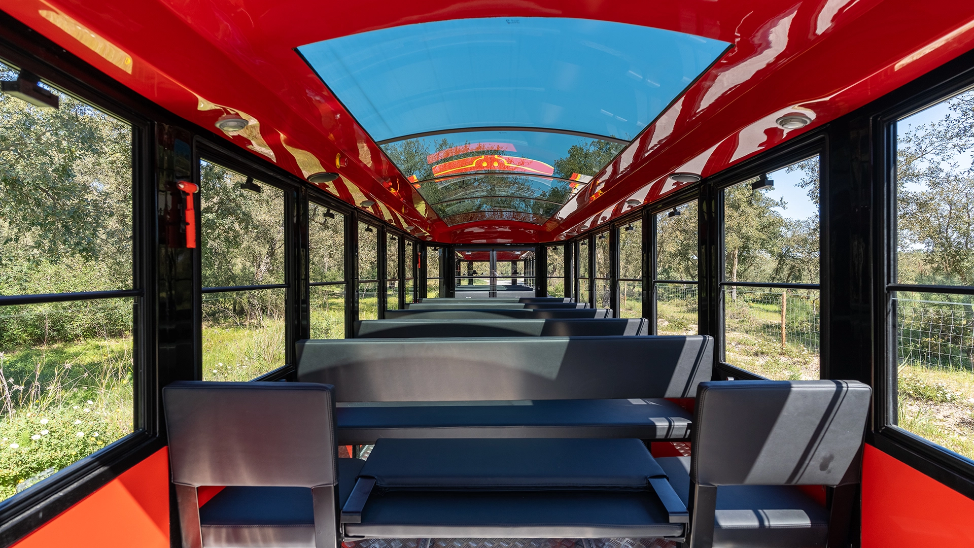 Interior of a Deltrain Prime enclosed wagon with forward-facing bench seating along a central aisle