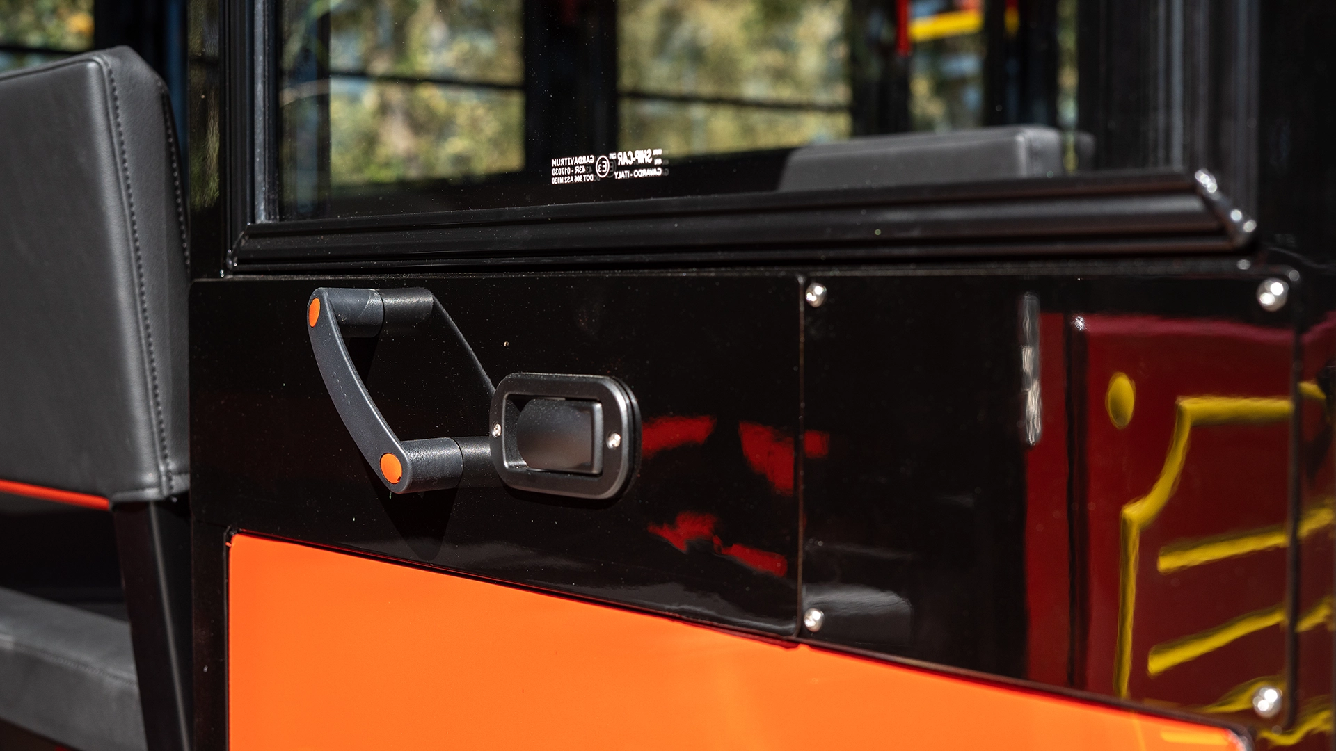 Side mirror, sliding glass window, and gold scrollwork on a Deltrain Prime enclosed wagon