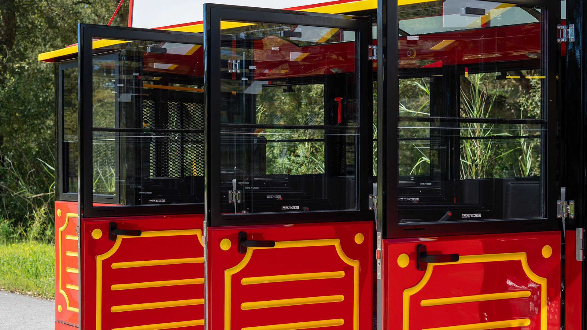 Ornate red and gold decorated side panel and door of a Deltrain Prime enclosed wagon